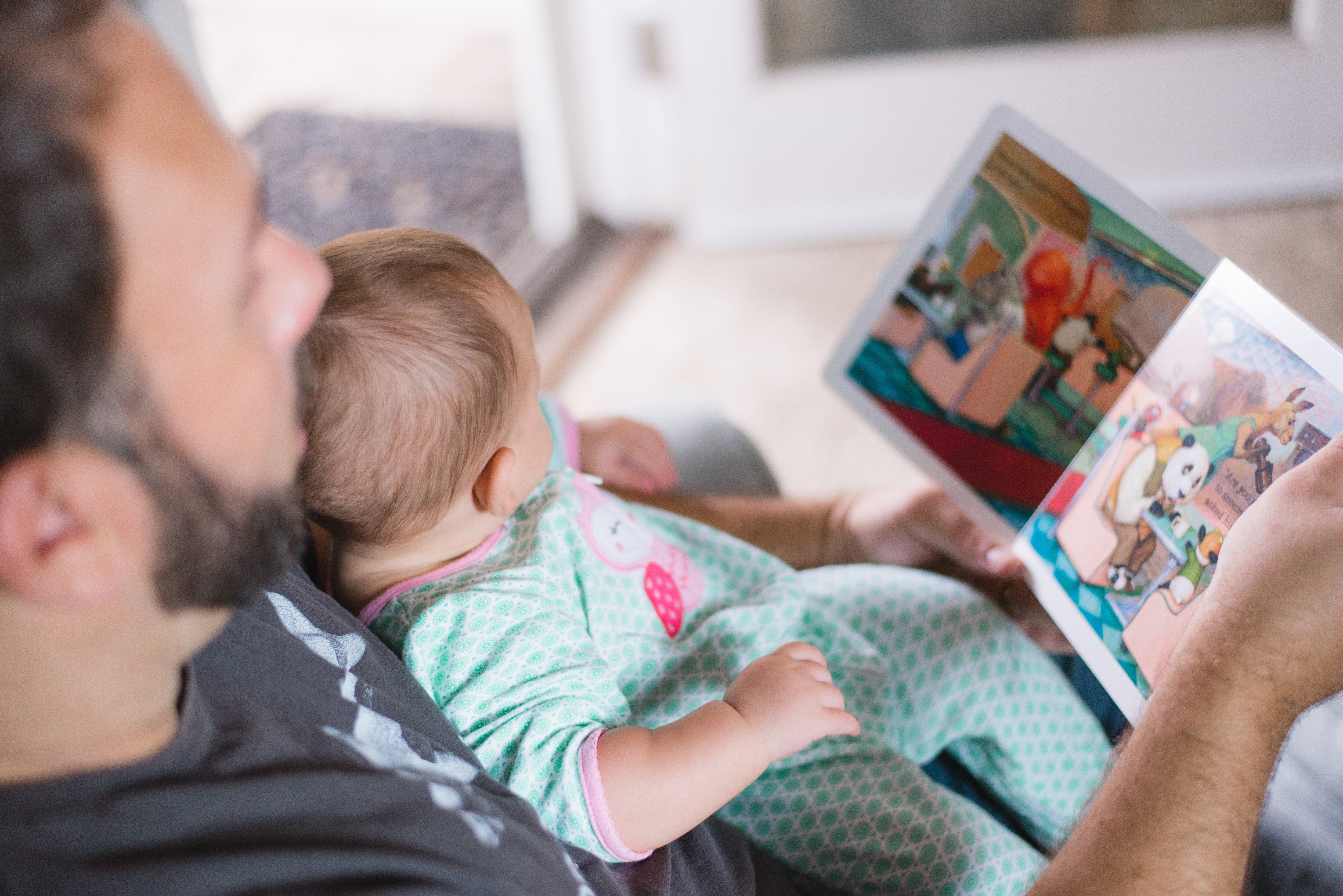 Dad reading his child a book