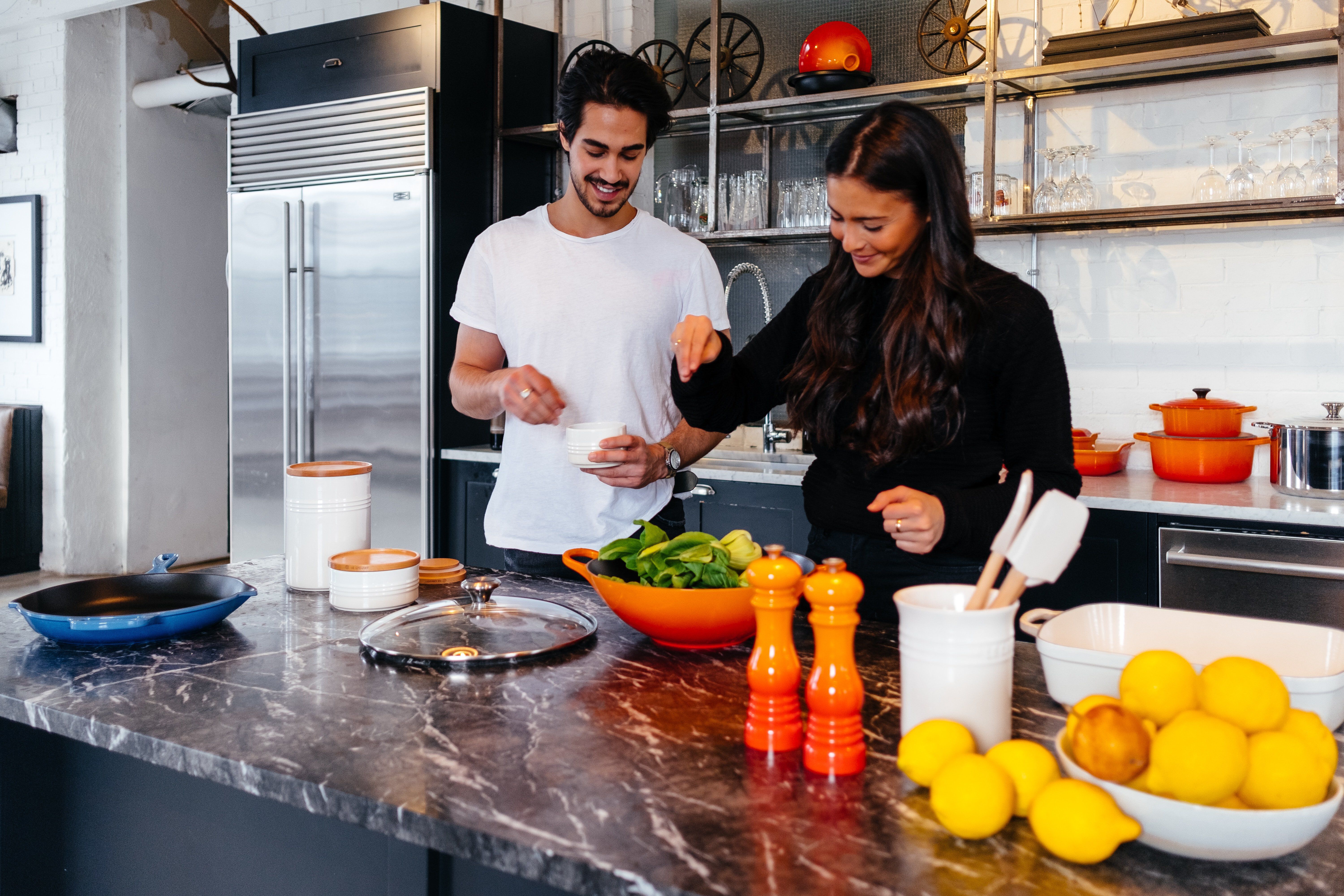 two people cooking together