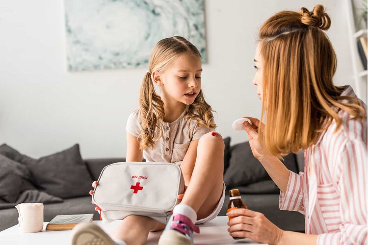 mom putting a bandage on her child