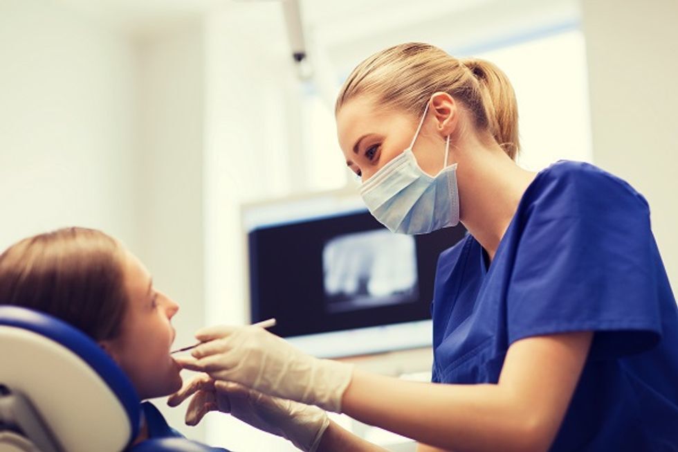 A person at the dentist being examined