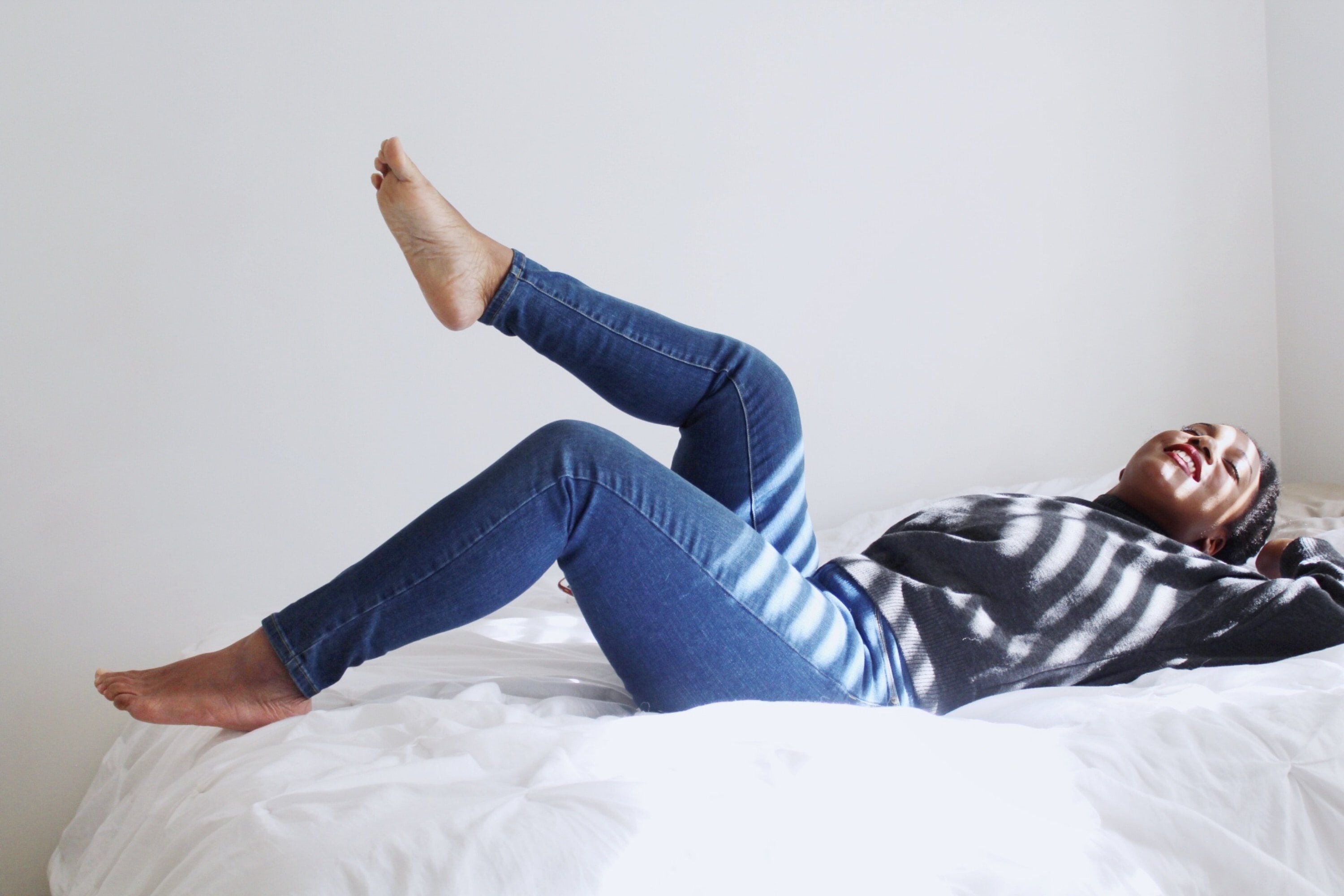 A woman relaxing on a bed